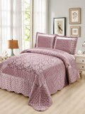 A mauve colored quilt with shimmer texture