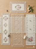 Set of lace doilies with floral and geometric patterns on a wooden surface.