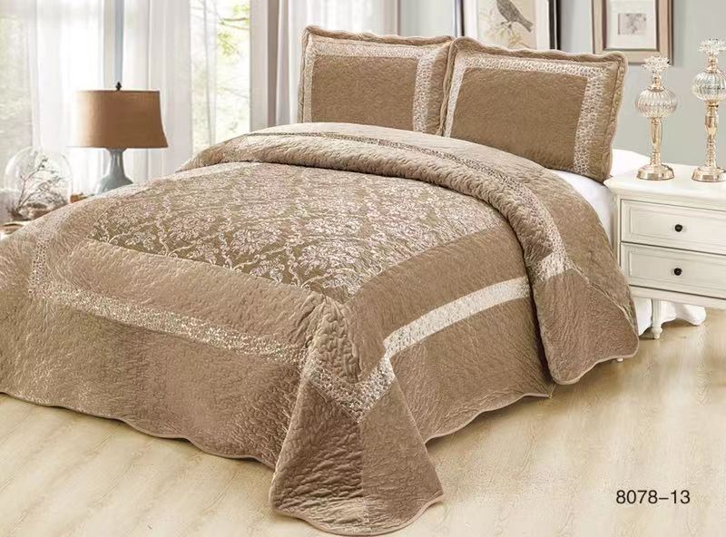 Brown textured comforter set on a bed with matching pillows in a bedroom setting.