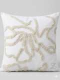 Decorative pillow with beige coral pattern on a white background