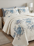 Floral patterned bedspread on a bed in a bedroom setting